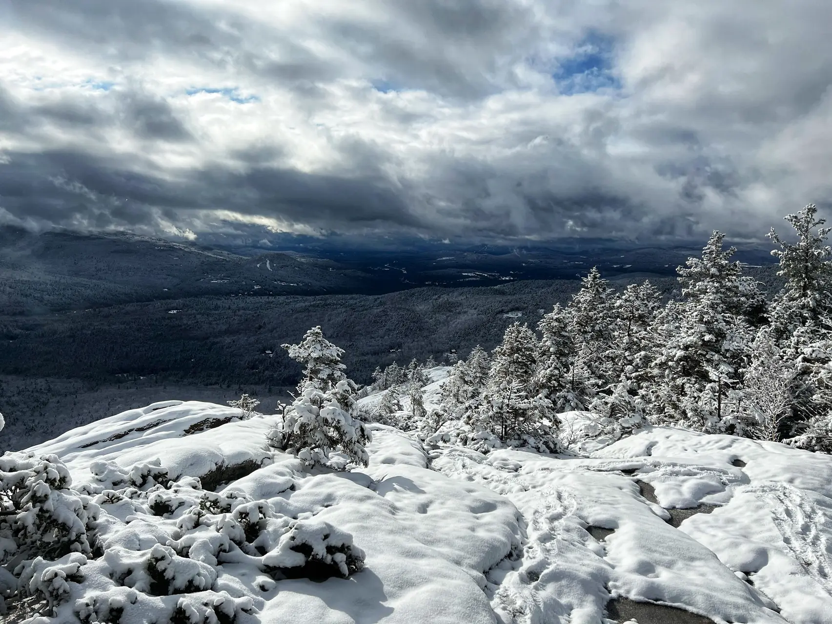 Snow covered White Mountains vista with snowy evergreens under a cloudy winter sky in New Hampshire